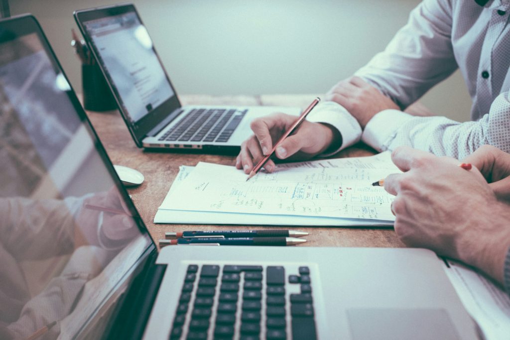 Two lap top computers being used by a technical SEO copywriter for real estate