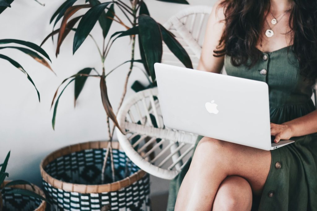 A writer working on her laptop to create compelling narratives for businesses.