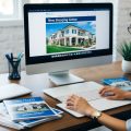 A freelance writer for commercial real estate working in her office on a blog post to promote a new shopping center.